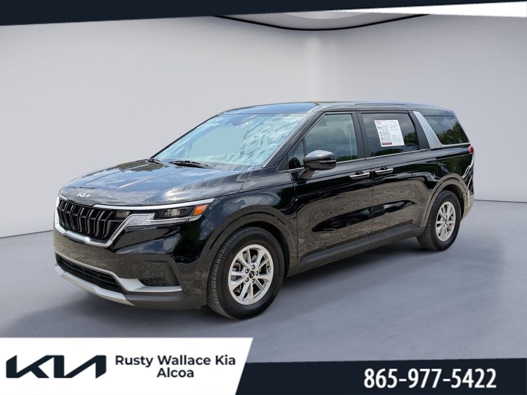 2022 Kia Carnival LXS in Aurora Black — front three-quarter view