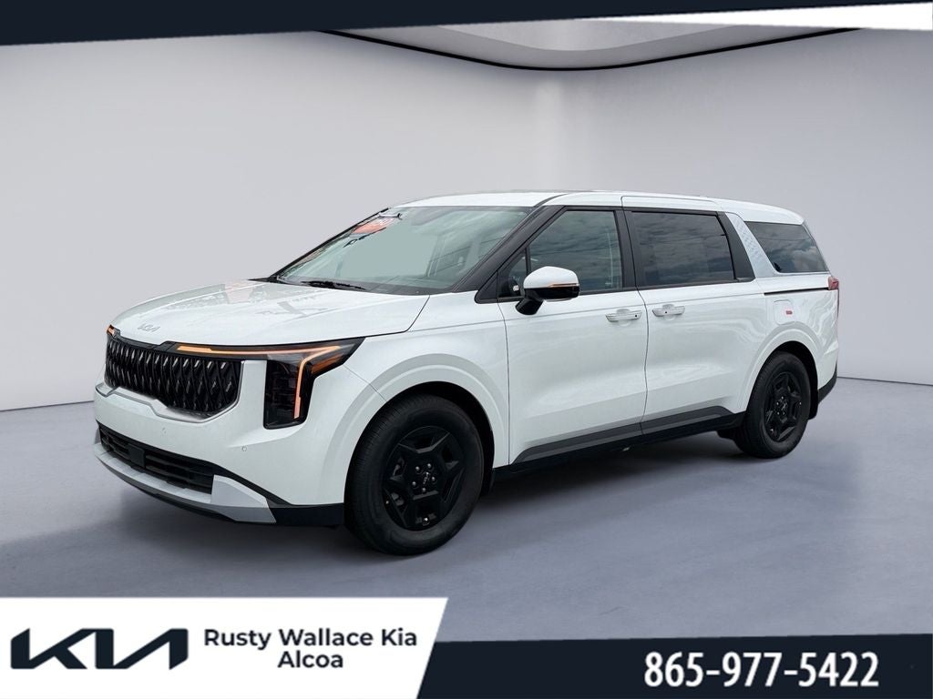 2026 Kia Carnival LX in Snow White Pearl — front three-quarter view