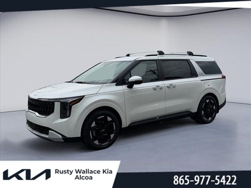 2026 Kia Carnival EX in Snow White Pearl — front three-quarter view